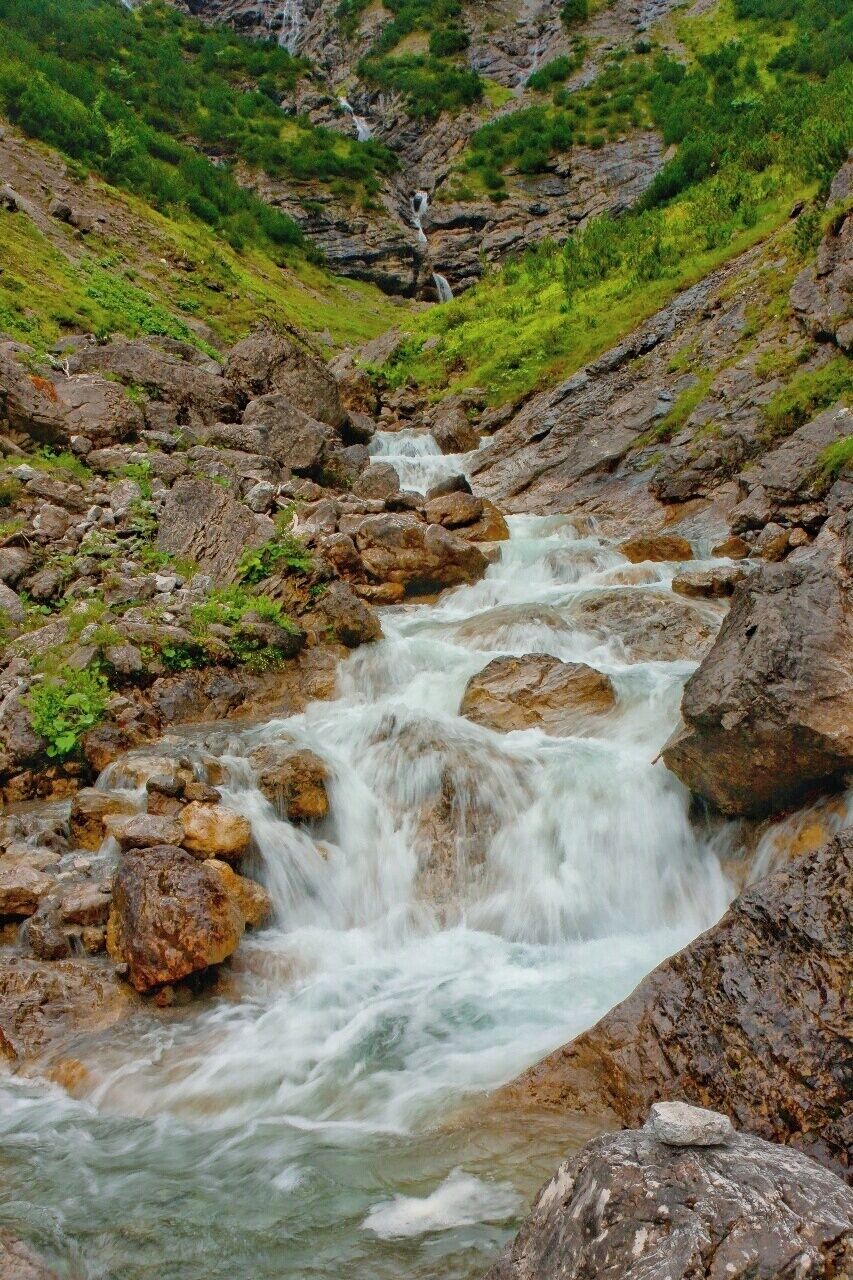 July 2015 

Otterbach creek, Lechtal Alps 

Otterbach creek as seen at the beginning of the valley running to the village of Gramais in Lechtal Alps in Austria. It is almost the end of the round trek from Gramais over Memminger Huette and back. The descend from Memminger Huette takes some 3 to 4 hours and for us it was quite tough as we had to do it in the full mist and slight rain. However an experience does not have to be always pleasant as long as it is strong :) 