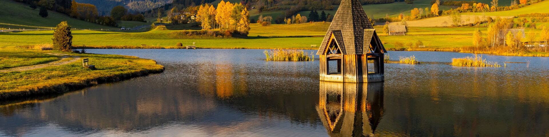 autumn pond under the mountains, Murau district,.Styria, Austria