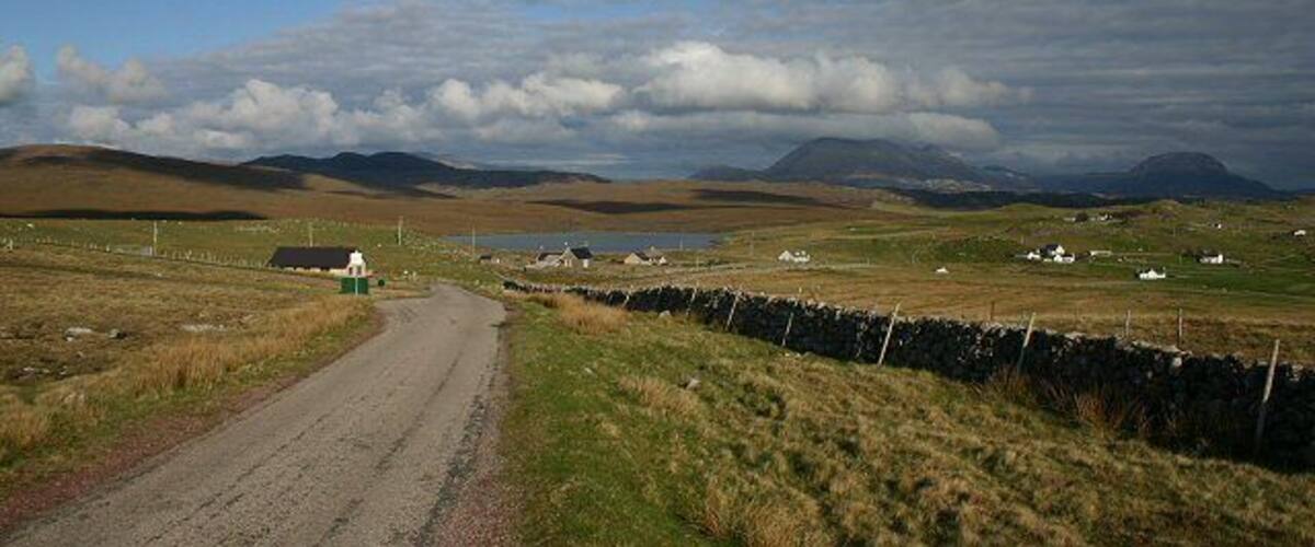 Road from Blairmore to Kinlochbervie In the middle distance is Loch Aisir Mòr; behind are the distinctive mountains Foinaven and Arkle.