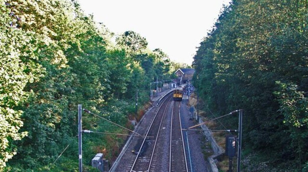 Train leaving Winchmore Hill Station towards Enfield Chase. Looking southwards over the bridge towards Winchmore Hill Station, with a train leaving the station on the northbound track.