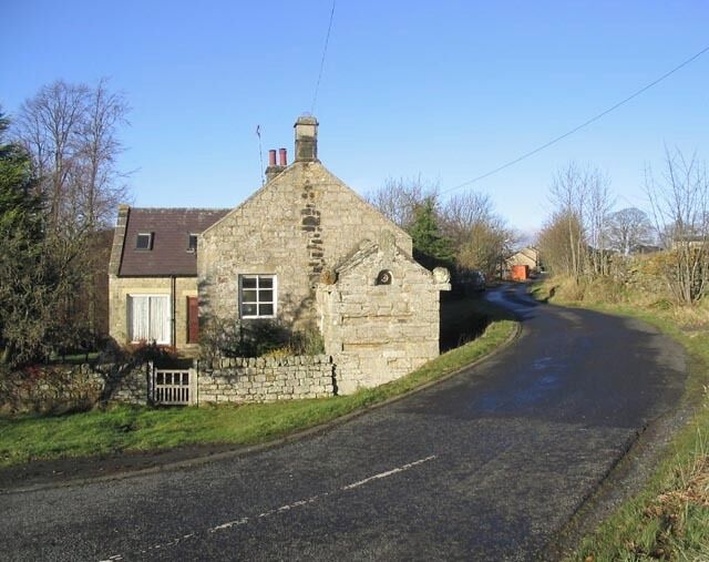 The road to High Rochester This house sits at the junction of the A68 and the minor road to High Rochester.