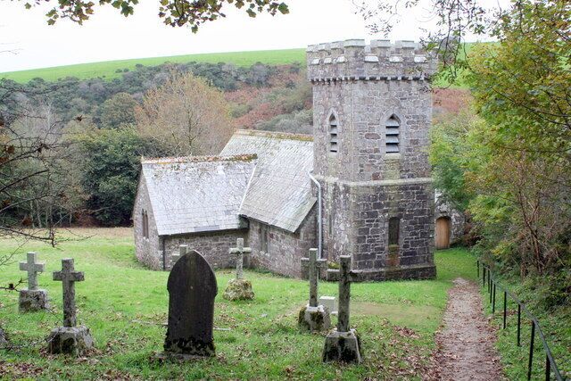 A stone church with a tower and a graveyard with crosses.