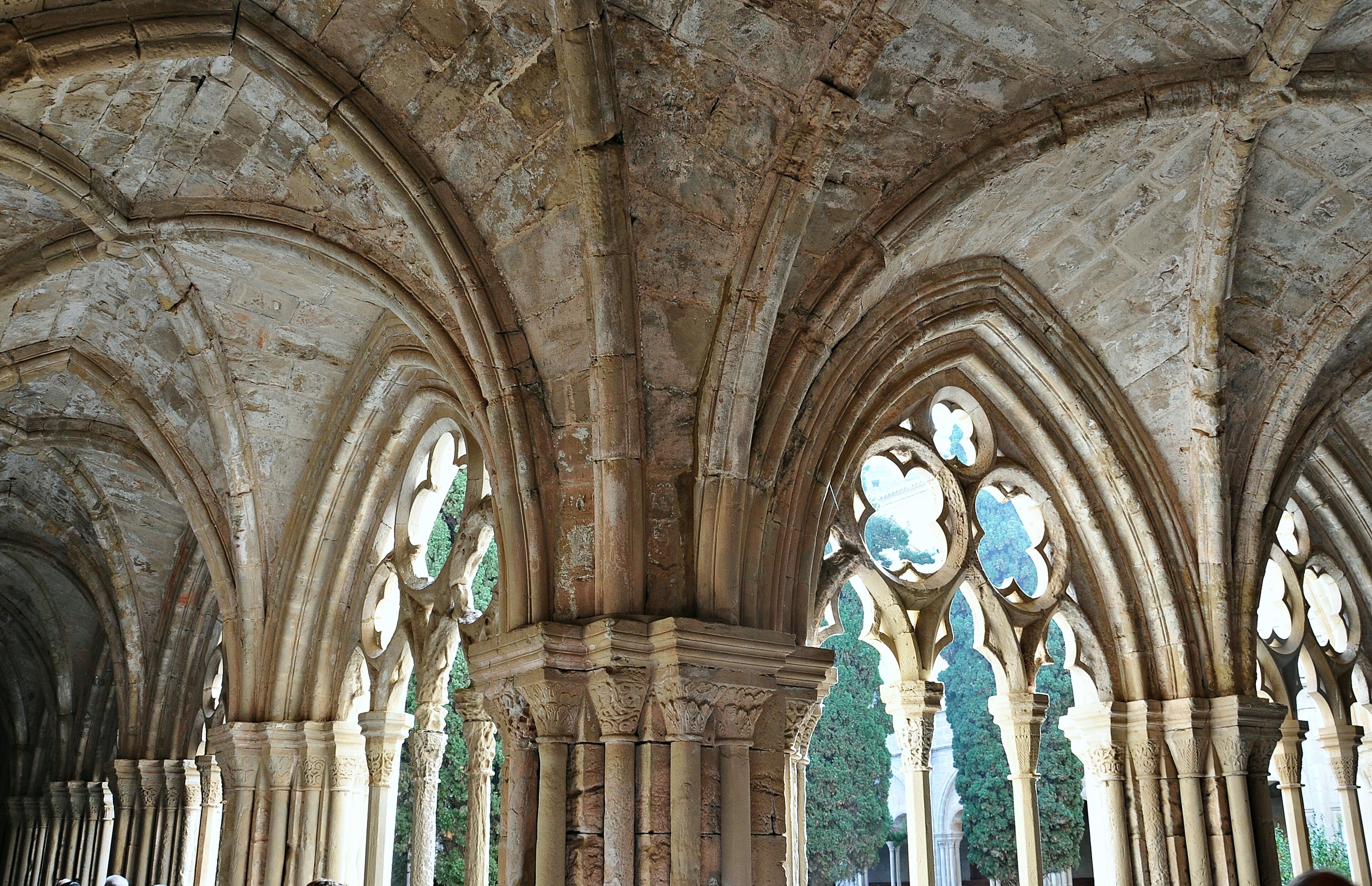 A stone cathedral interior with arched ceilings and columns.