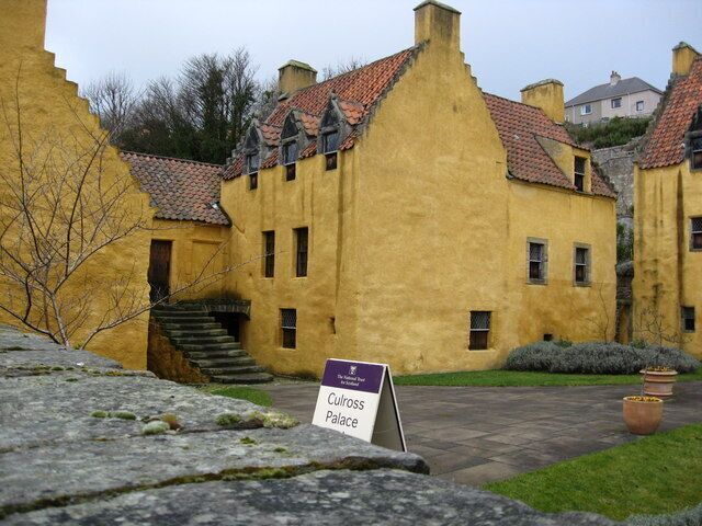 A yellow building with a sign reading "Culross Palace."