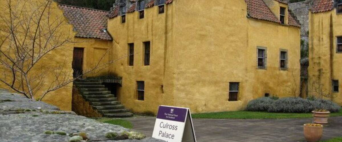 A yellow building with a sign reading "Culross Palace."