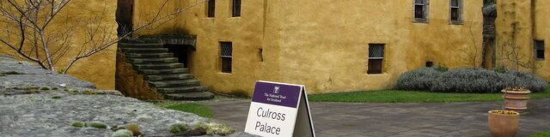 A yellow building with a sign reading "Culross Palace."