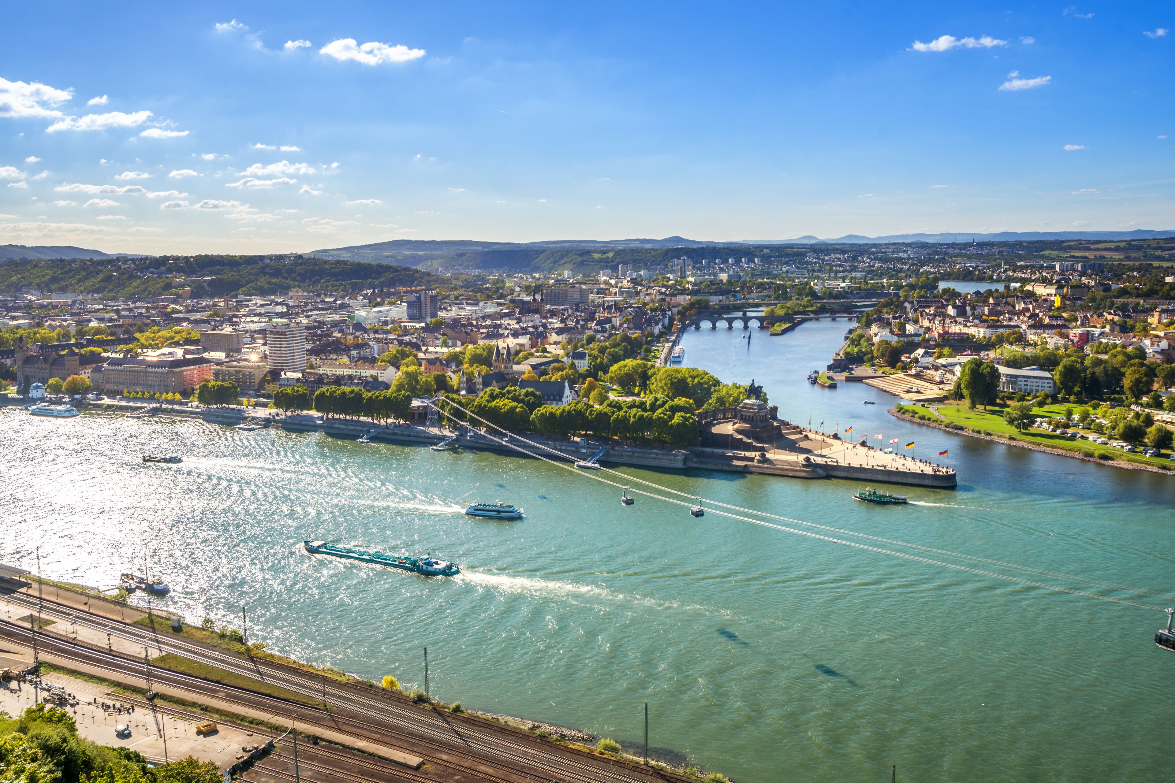 A river with boats, a bridge, and a cityscape.