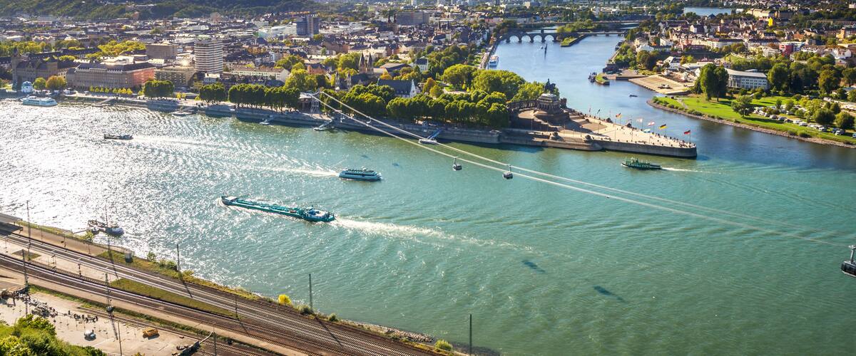 A river with boats, a bridge, and a cityscape.