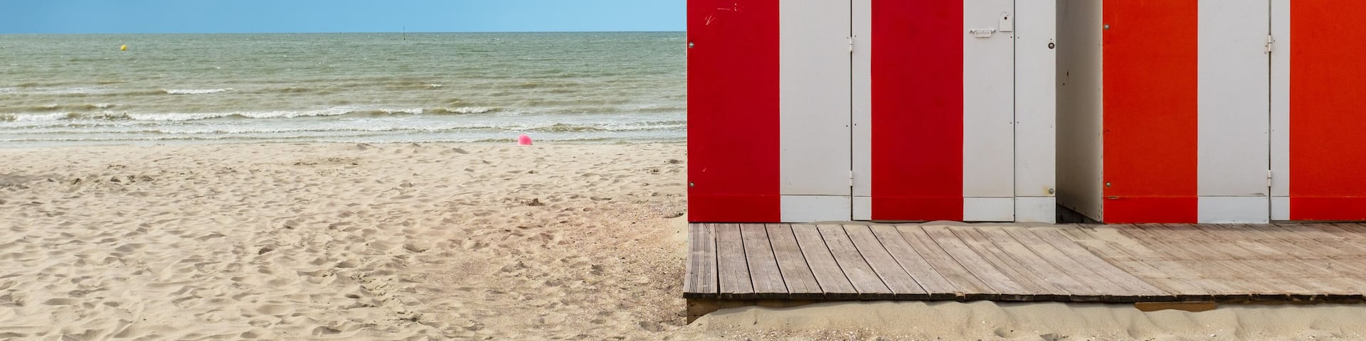Row of vintage wooden beach huts on the beach of Dunkirk in France