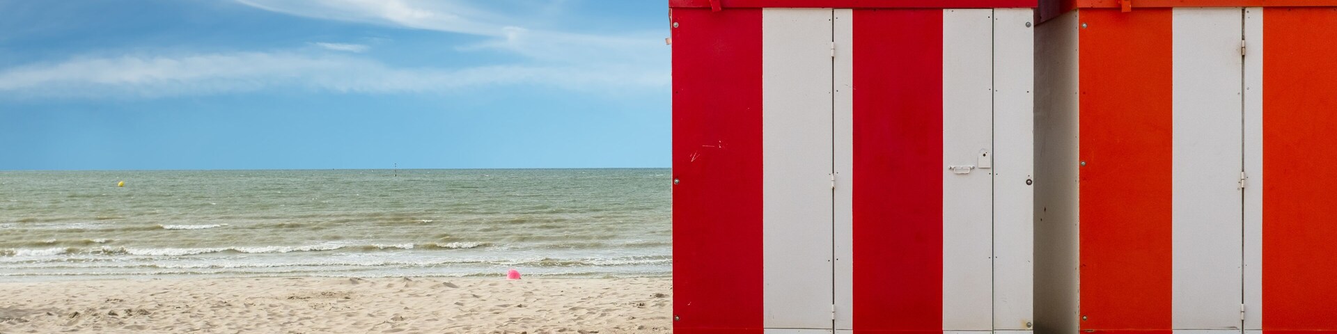 Row of vintage wooden beach huts on the beach of Dunkirk in France