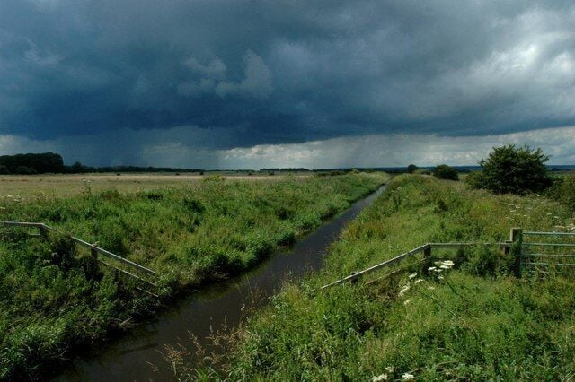 The River Hertford from Flixton Bridge, looking west Looking towards the former Mesolithic lake settlement of Star Carr. The approaching thunderstorm in the distance inflicted the soaking of a lifetime on the photographer!