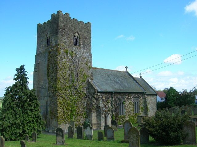 A historic church with a tower and a graveyard.