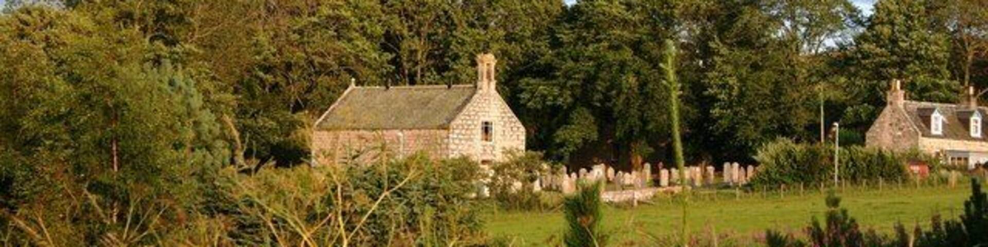 Leslie Kirk Half hidden by trees the kirk and kirkyard of Leslie.