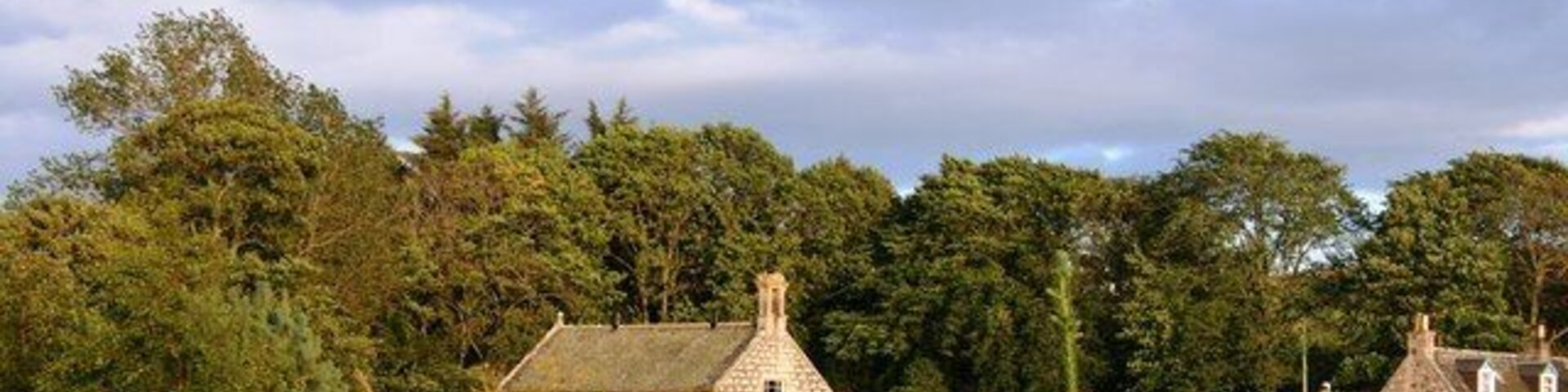 Leslie Kirk Half hidden by trees the kirk and kirkyard of Leslie.