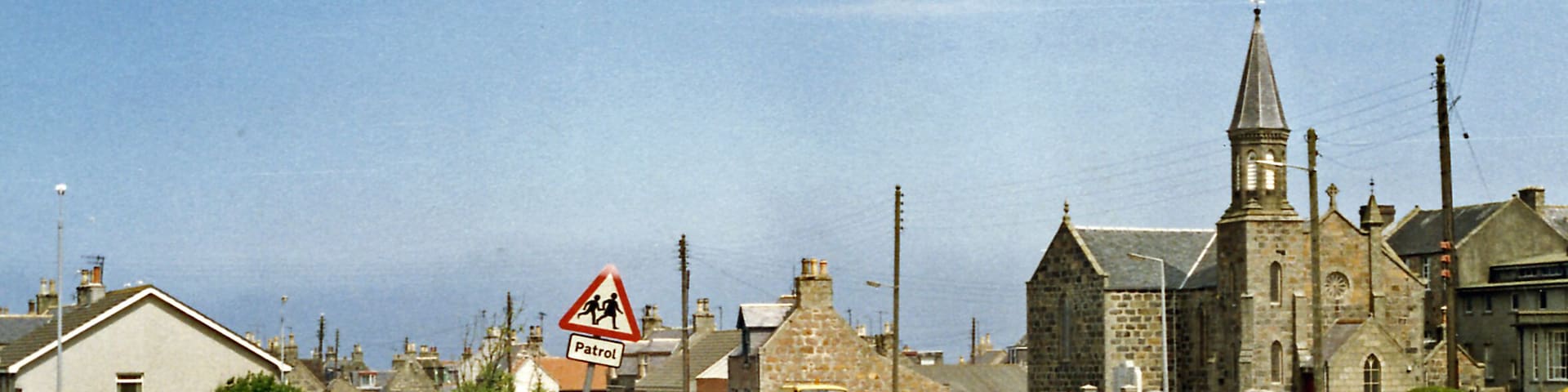 Cairnbulg: site of station, 1988. View NE on B9107 to Inverallochy where the ex-GNS Fraserburgh (left) - St Combs (right) light railway crossed. The station and line were closed from 3/5/65.