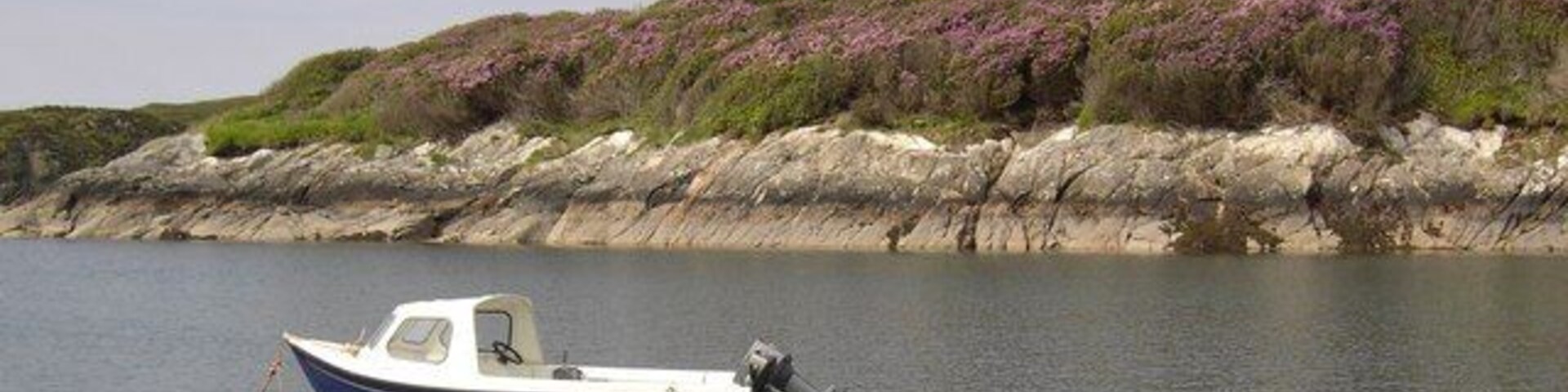Boat on Loch Leosavay A small boat on Loch Leosavay in front of Abhainnsuidhe Castle.