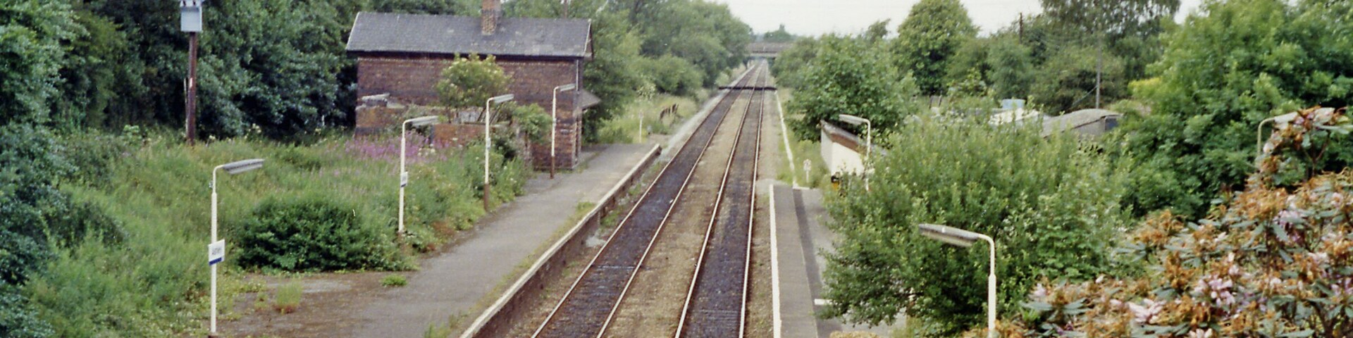 Ashley (Cheshire) station, 1992. View northward, towards Altrincham and Manchester: ex-Cheshire Lines (CLC) Manchester - Altrincham - Northwich - Chester secondary main line. Since 5/5/69 when Manchester Central closed, the service has run via Oxford Road to Piccadilly and on 6/10/69 their Chester Northgate terminus was closed and the trains then ran to Chester General.