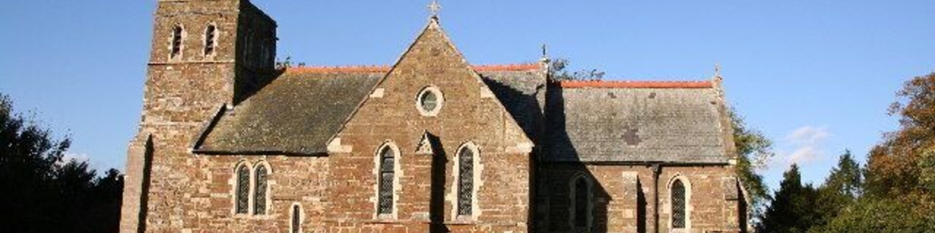 St Julian's parish church, Benniworth, Lincolnshire, seen from the south. 12th-century origins but almost entirely rebuilt in 1875 to designs by James Fowler of Louth. He re-used a Norman west doorway, Early English windows and a Perpendicular Gothic screen.