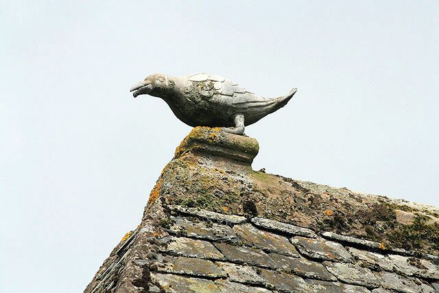 Roof detail at Traquair House. This lead ridge finial on the north wing roof 895638 represents a crow, which is part of the family crest.