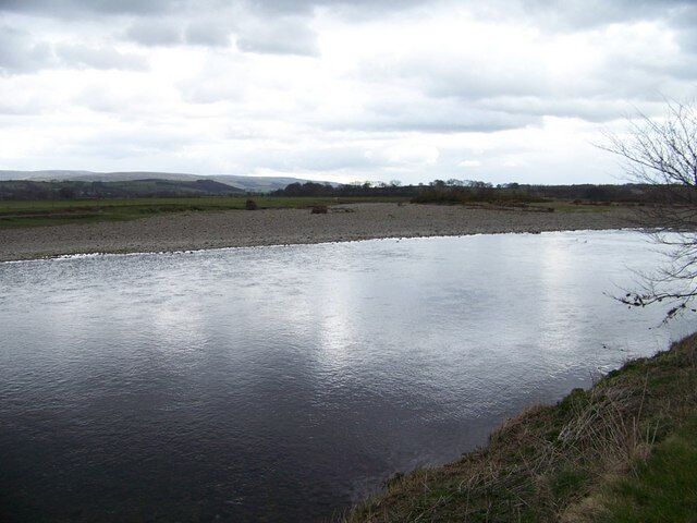 Island in the Lune Evidence of dead trees left high on the pebbles shows that in full flow the river does take the short cut to make an island of the land in the mid-right of the photograph. The river on this day was low(ish).