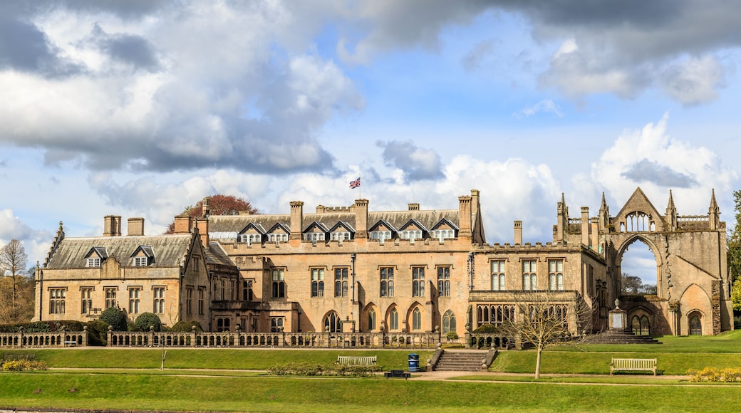 A historic building with a large arched entrance and a flagpole.