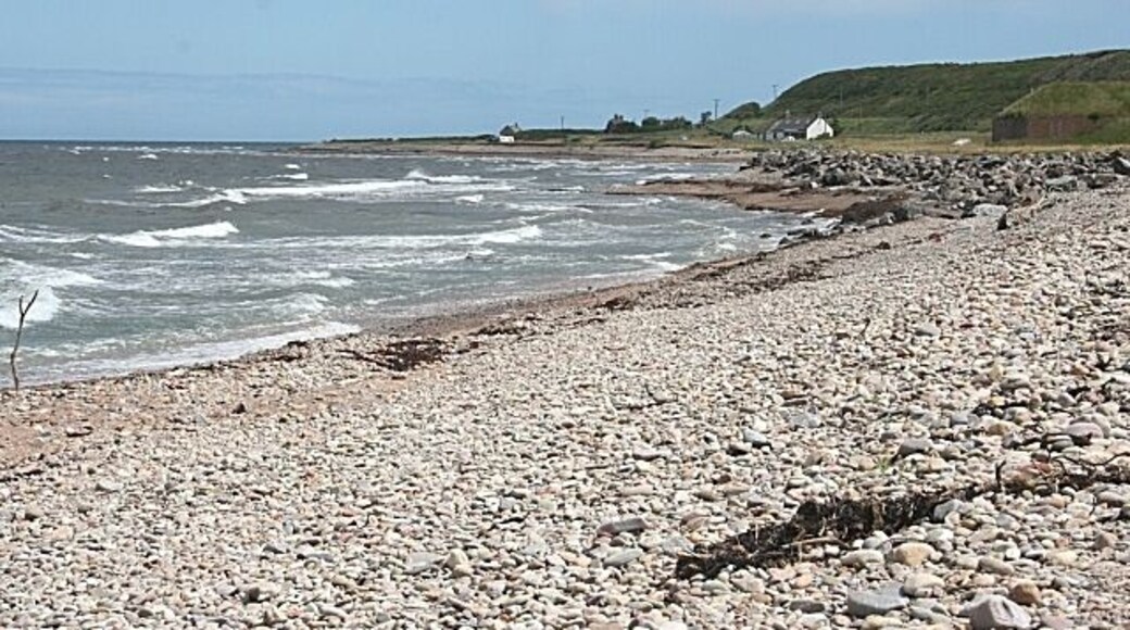 Beach at Gollachy I think the large boulders at right have been placed there to prevent erosion by the sea which might threaten the old ice house.
