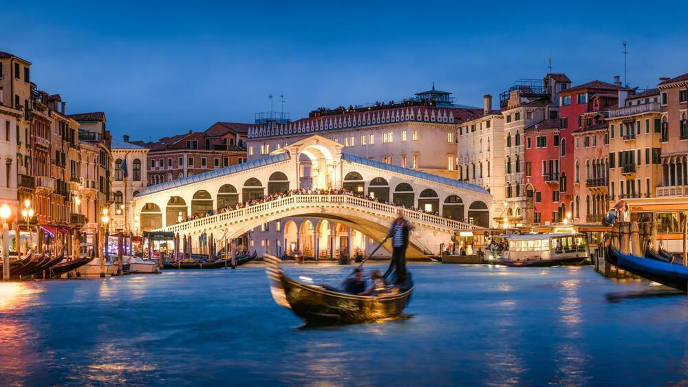 Romantic gondola ride near Rialto Bridge in Venice, Italy