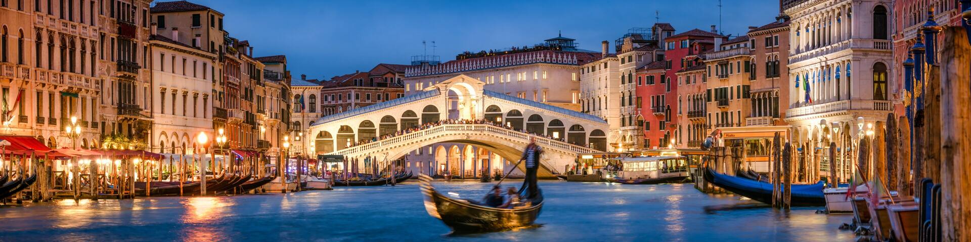 Romantic gondola ride near Rialto Bridge in Venice, Italy