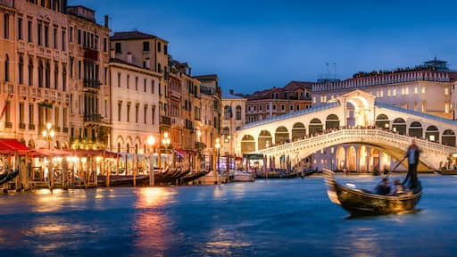 Romantic gondola ride near Rialto Bridge in Venice, Italy