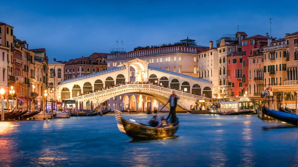Romantic gondola ride near Rialto Bridge in Venice, Italy
