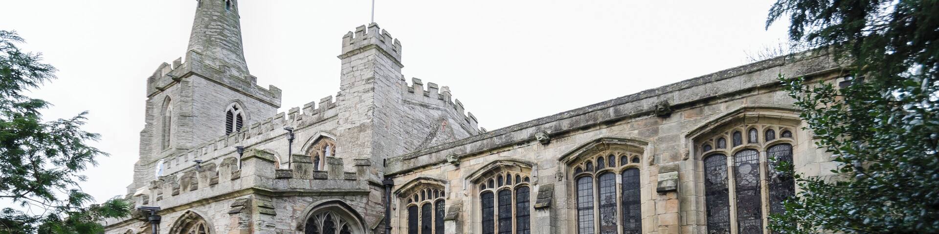 The church dates back to the 12th century, and is there was a Chapel Of Ease here in 1179. The church is built from Skerry stone and has nave with clerestory, embattled, north and south aisles, chancel, north and south porches and a western tower with pinnacles and spire. It has six bells. At the east end of each aisle there was a chantry. The tower dates from the early 14th century, with a late 14th century broached spire. The north arcade has circular piers dating from the 13th century, the south arcade has octagonal piers from C.1300. The chancel was built in 1495, the gift of Thomas Gunthorpe. There is a 15th century screen with elaborate tracery. The South porch dates from around the same time. The font dates from 1662 with a large elaborate cover suspended from the roof. In the 18th century the north Chantry Chapel was enlarged into the White's Chapel, and it contains a monument to Sir John white, d.1625. There are also two mutilated 14th century effigies of a cross-legged Knight and his lady. The church was restored several times in the 19th C, notably in the 1890's, and again in 2013 when the pews were cleared, new heating and a Kitchen was installed. The church contains some stained-glass from circa 1500 depicting Saint Laurence, this is in poor condition and has been reset. The rest is 19th century.