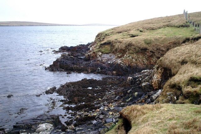 Coastline west of Ulsta The island of Bigga in Yell Sound is on the horizon.