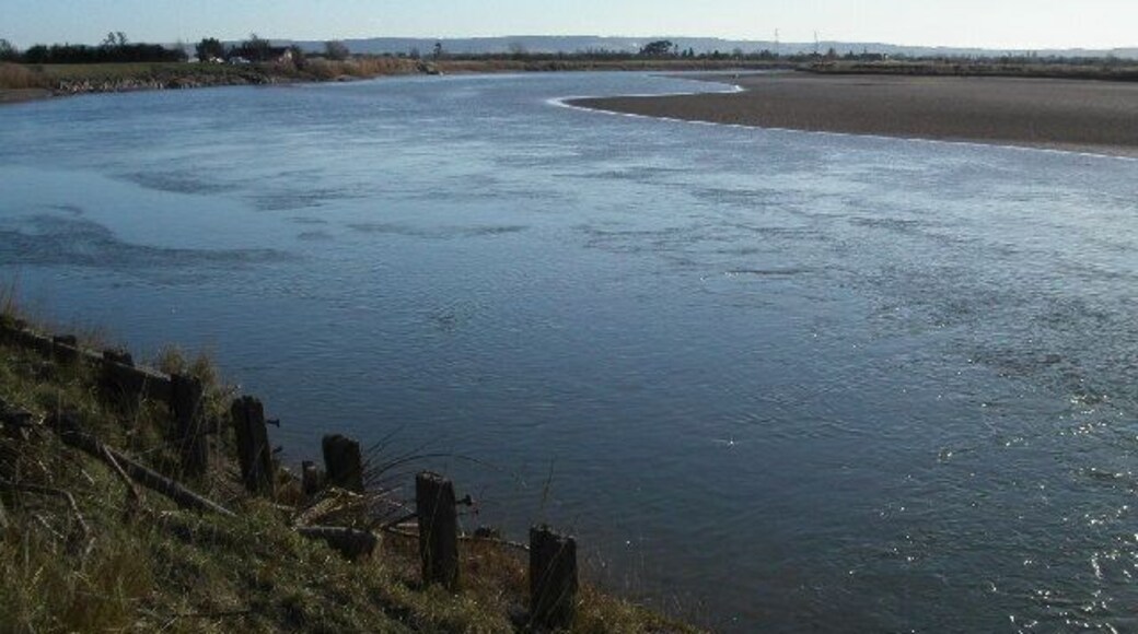 Longney Crib on the river Severn. Longney Crib is a narrow section of the river Severn. The tidal bore after its journey around the magnificent horseshoe bend at Newnham now starts to get squeezed. The photo is looking south towards the crib. The tide is receding leaving large areas of sand and mud.