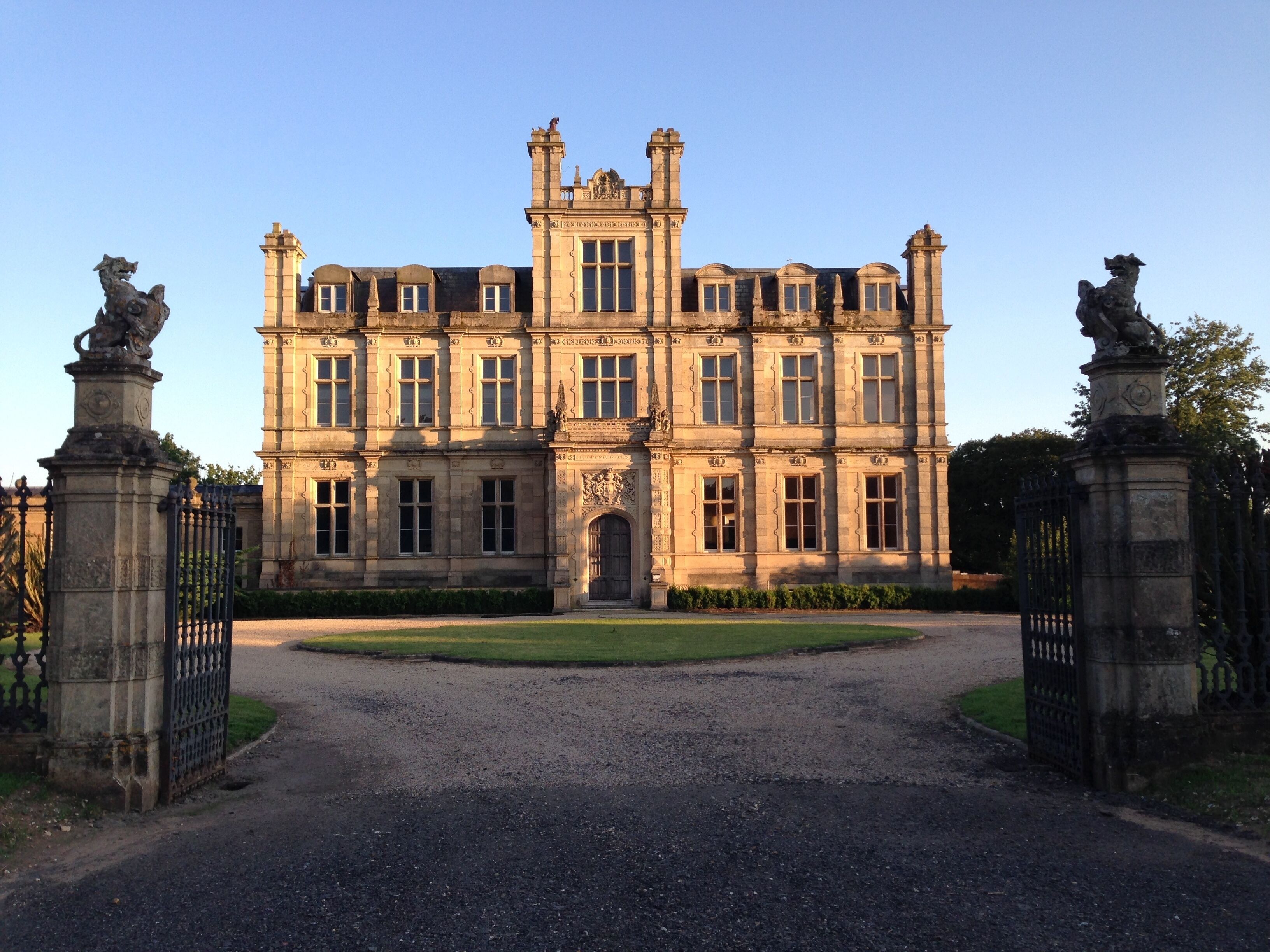 A large, historic building with a symmetrical facade, large windows, and a central entrance.
