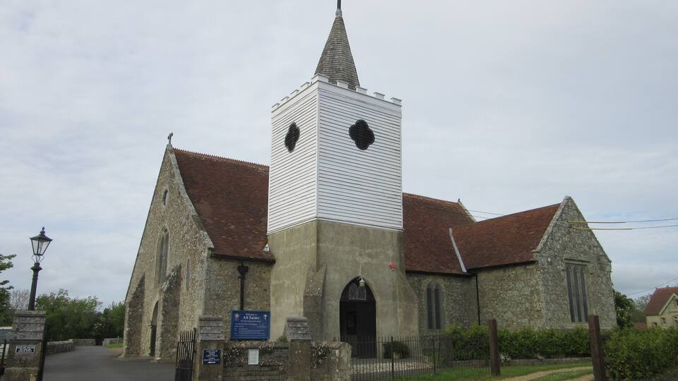 A church with a tall tower and a clock.