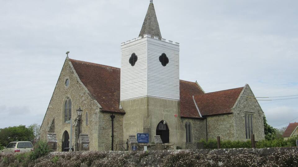 A church with a tall steeple and a bell tower.