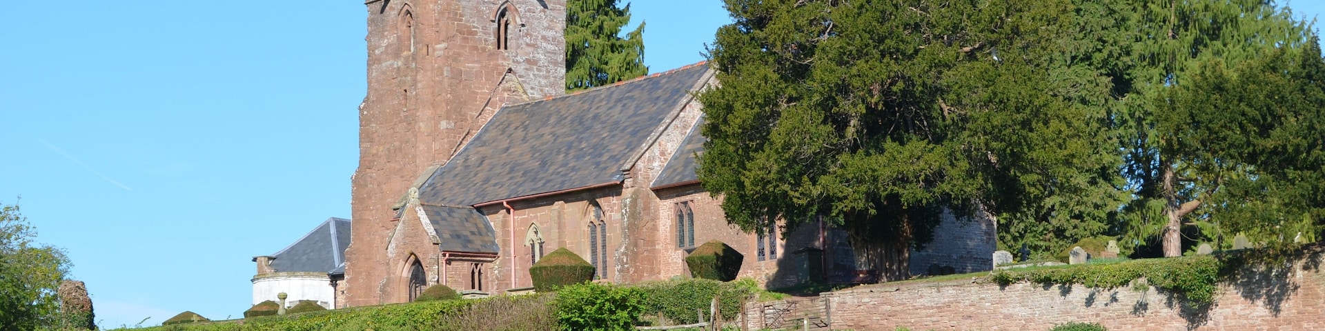 Grade I listed. The church dates from the 13th century when the nave and chancel were built. In the 14th century the west tower and south porch were added. The nave roof dates from the late 14th, early 15th century, with a 19th century copy in the chancel. The tower has six bells dating from the 18th C. and a Sanctus bell from the mid 17th century. The tower may once have had an octagonal spire. The font dates from the 14th century and is decagonal. It also has the largest bowl in Herefordshire. In 1673 the east wall of the chancel was rebuilt and the stained glass in the east window replaced. The 17th century also saw the installation of a six sided pulpit, communion rail, the screen, and stalls in the chancel. The church was restored in 1863 when the current pews and organ were installed. The church contains several monuments to the Abrahall family. There is also a 13th C. effigy and an altar tomb to Sir Hugh Waterton from the late 14th C. The churchyard enjoys spectacular views across the Wye Valley.