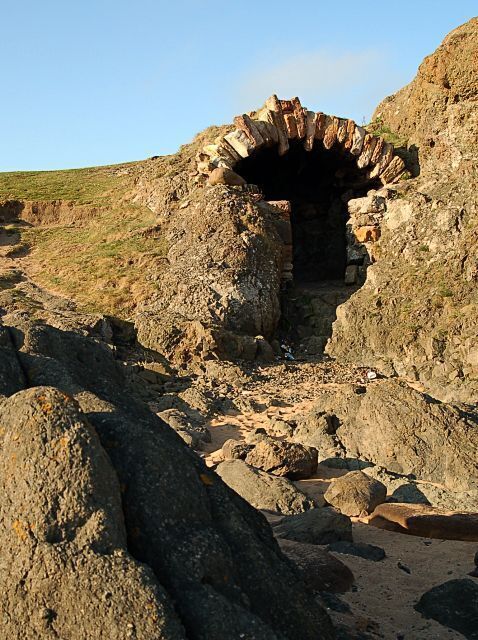 A rocky cave entrance with a narrow passageway.