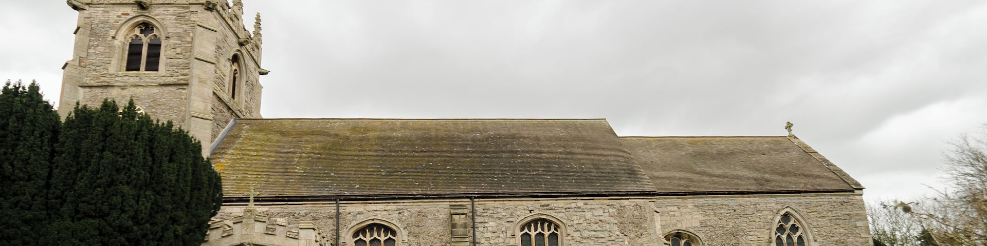 The church dates from the early 12th century onwards, with evidence of Norman herringbone masonry. The church was restored in the 19th century and again in 1907. There is a western tower, aisleless nave, south porch and chancel. The tower is of two stages and is topped by a parapet with shields and eight crocketted pinnacles with gargoyles. The upper portion of the tower is later than the base, 14th to 15th century. There are six bells. The south porch dates from the early 16th century, and has its own gargoyles. There are coats of arms referring to Sir Thomas Sutton above the door. The inner doorway is 15th century. The chancel has Early English windows, and was lengthened around 1400. The screen dates from a similar time (although is much restored). The chancel has a barrel roof which was installed in 1858. Located on the north wall of the chancel adjacent to the altar, is a monument to Sir William Sutton, died 1611, and his wife Susannah. He is shown in the usual supine position with his hands in prayer alongside his wife. Unfortunately the hands were replaced after they were vandalised in 1984, and the monument was sprayed with paint. There is also a monument to Sir William's son, Robert, who died in 1668. His heart is said to be contained within the urn at the top. There are several 19th-century stained-glass windows, and a two light window of mediaeval glass which was reset by J. H. Sutton of Brant Broughton, circa 1885. There is also 20th century glass by Hincks and Burnell of Nottingham.