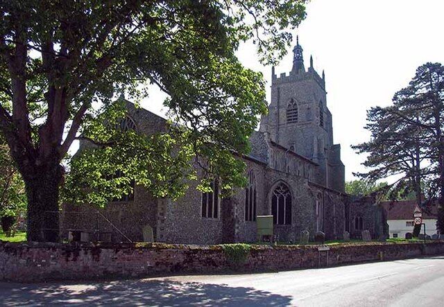 A historic church with a tall tower and arched windows.