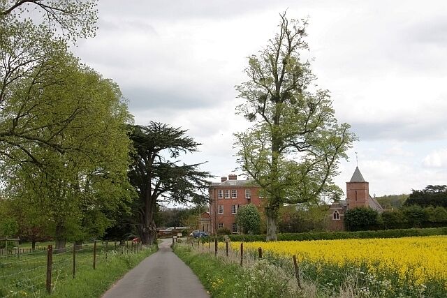 Approach to Canon Frome Court, Herefordshire, from the west, with the parish church of St James on the right