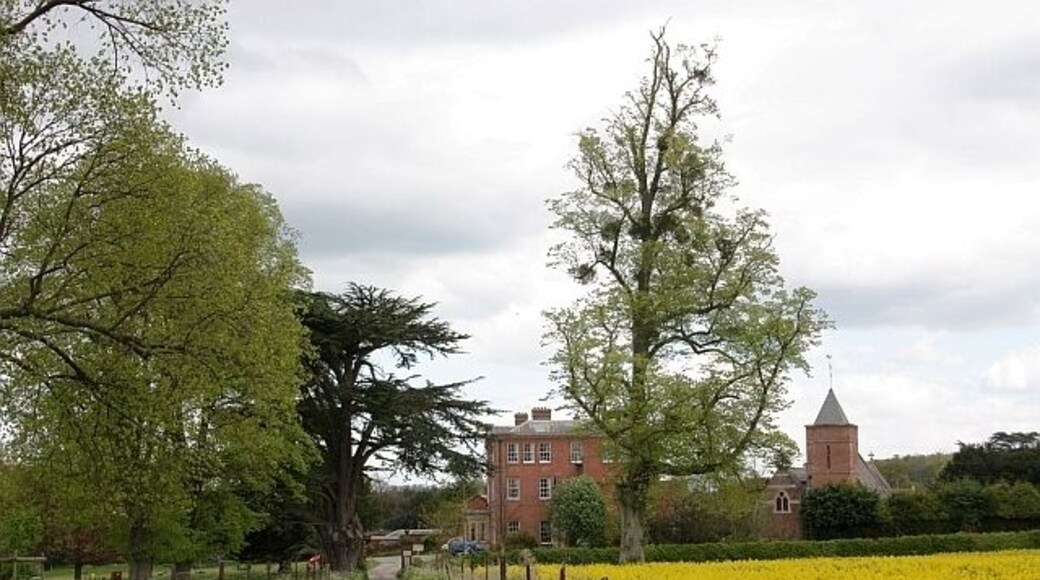 Approach to Canon Frome Court, Herefordshire, from the west, with the parish church of St James on the right