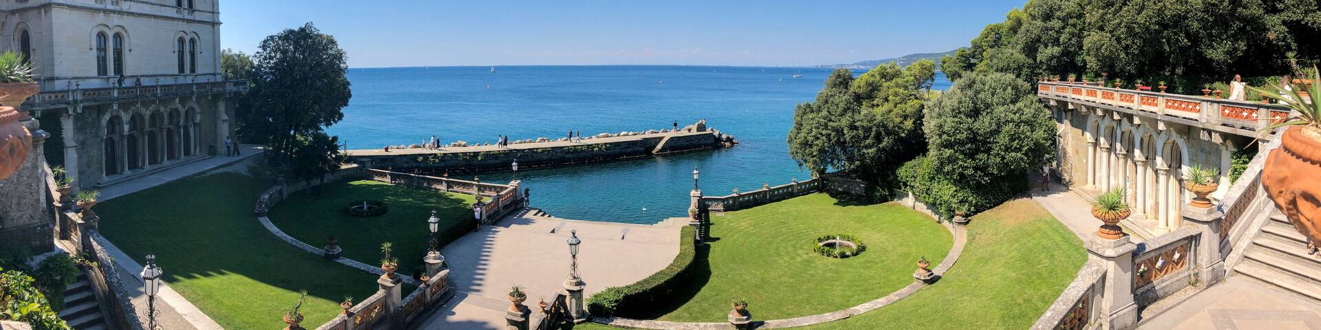 Entrance to the historical museum and park of Miramare castle, Trieste, Friuli-Venezia Giulia. 09-05-2021. People strolling in the open air by the sea. Italy