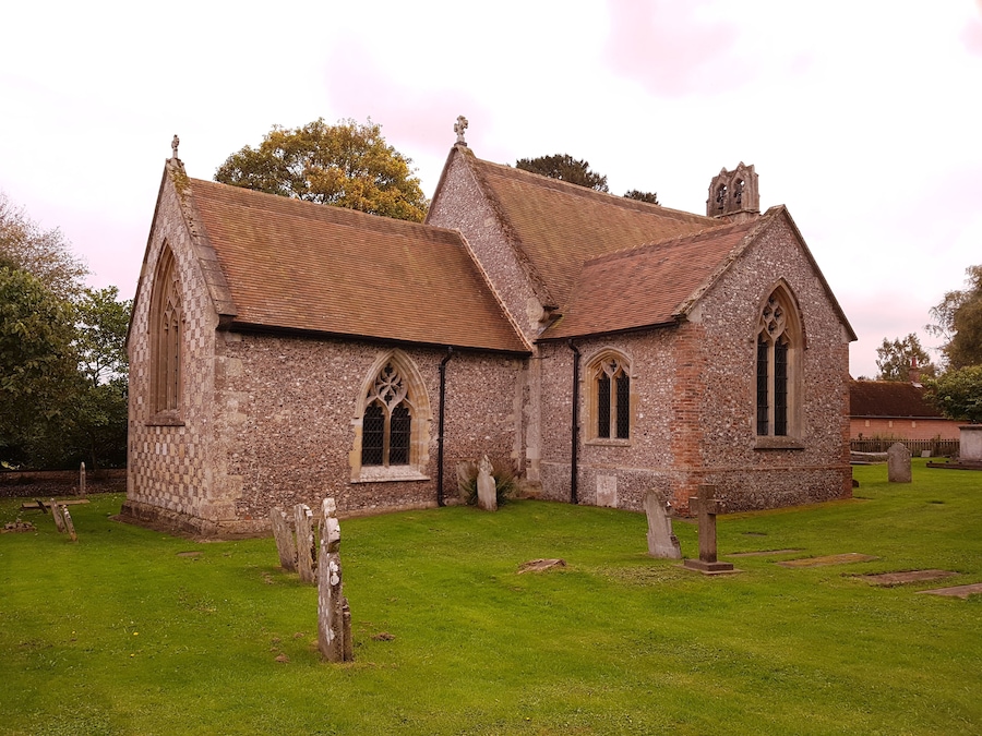 A historic church with a tiled roof and arched windows.