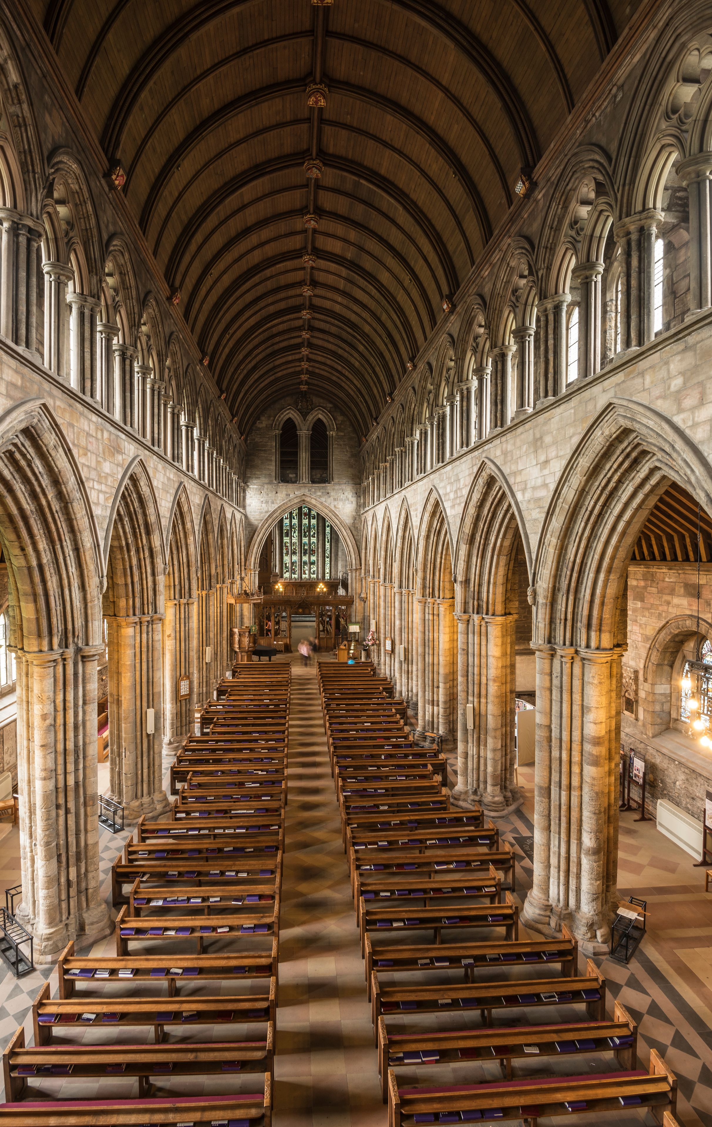A cathedral interior with arched ceilings and rows of wooden pews.