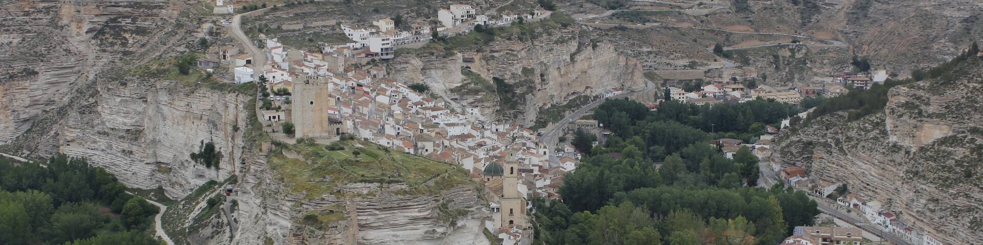 A town nestled in a valley with terraced houses and a prominent church.