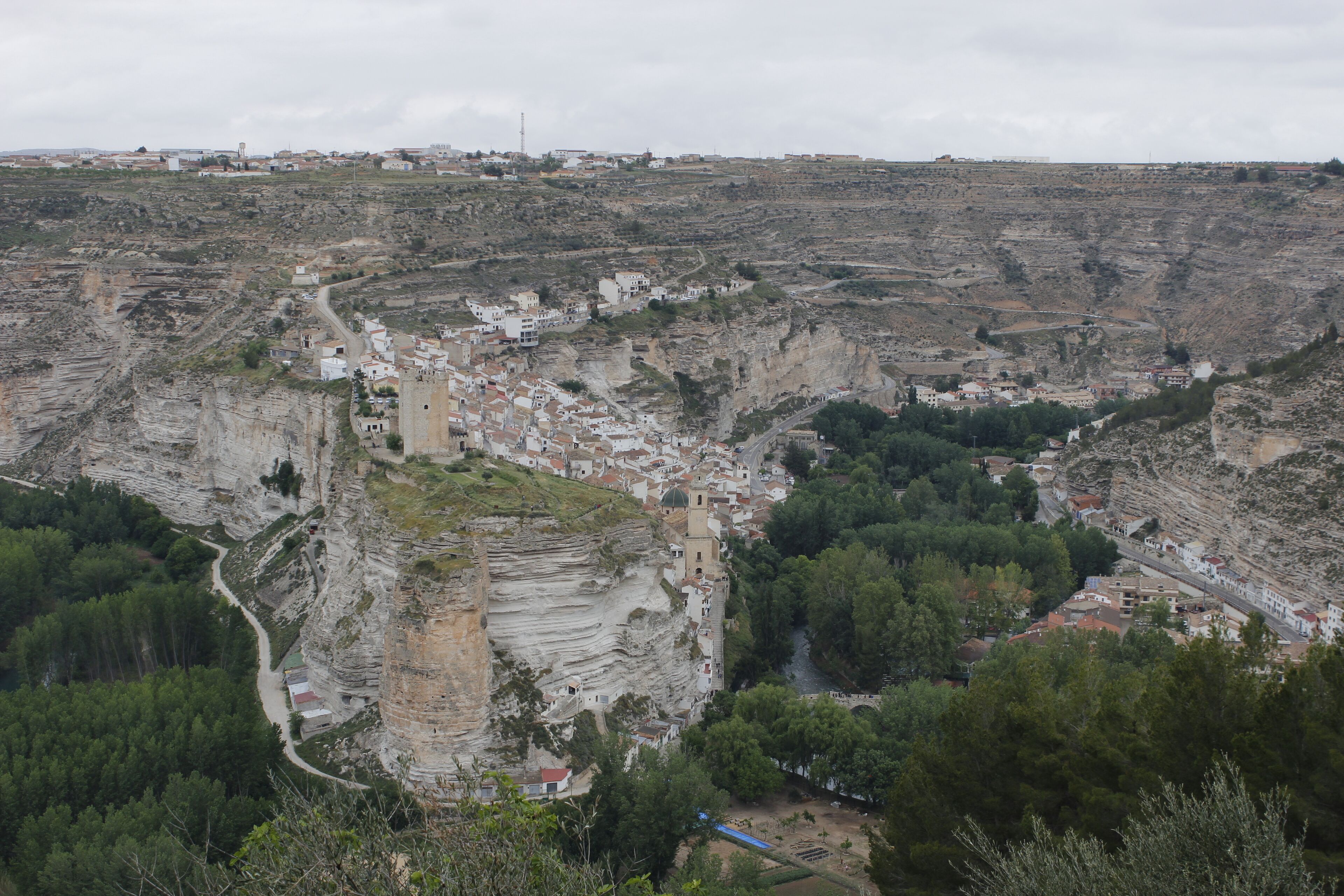 A town nestled in a valley with terraced houses and a prominent church.