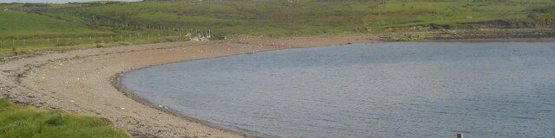 Shingle Beach, Sandwick. Looking across the small shingle beach at Sandwick towards Stoneyfield on Holm Farm.