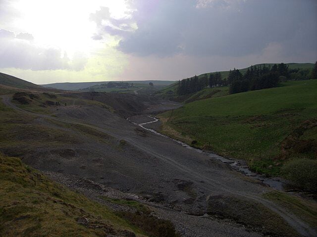 Dylife lead mines. The river bed of the Nant Dropyns or Afon Twymyn just downstream of Dylife (295469). The lead mining has left severe traces on the landscape: little vegetation can cope with the heavy metal concentration. I'm not clear about the name of the river at this point. My understanding was that it is called Nant Dropyns until it merges into the Nant Bryn-moel, which in turn becomes the Afon Twymyn downstream of the waterfall (809282) into the glacial Cwm Twymyn (809243). Fellow Geographer David Neal names this section, pictured from the opposite end (227660), Afon Twymyn.
