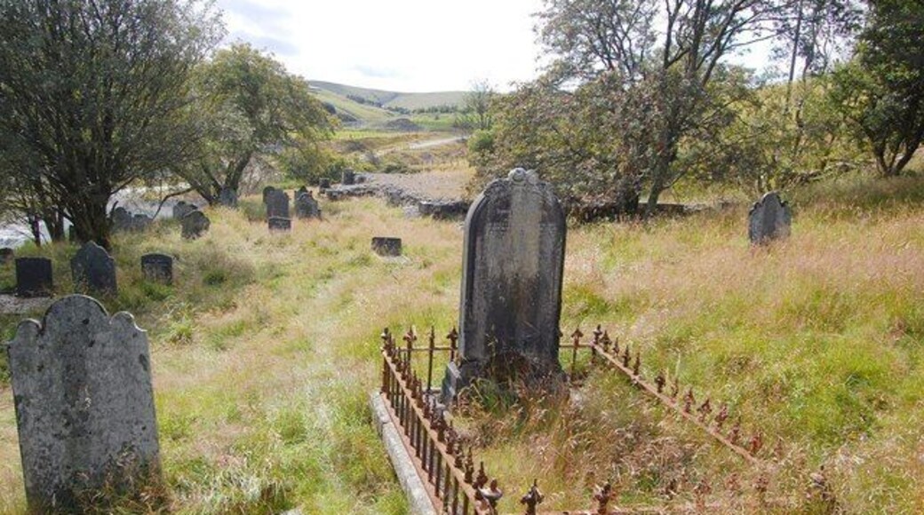Churchyard and Demolished Church, Dylife Beyond the central headstone the base of Dylife's former church, now demolished, can be seen.